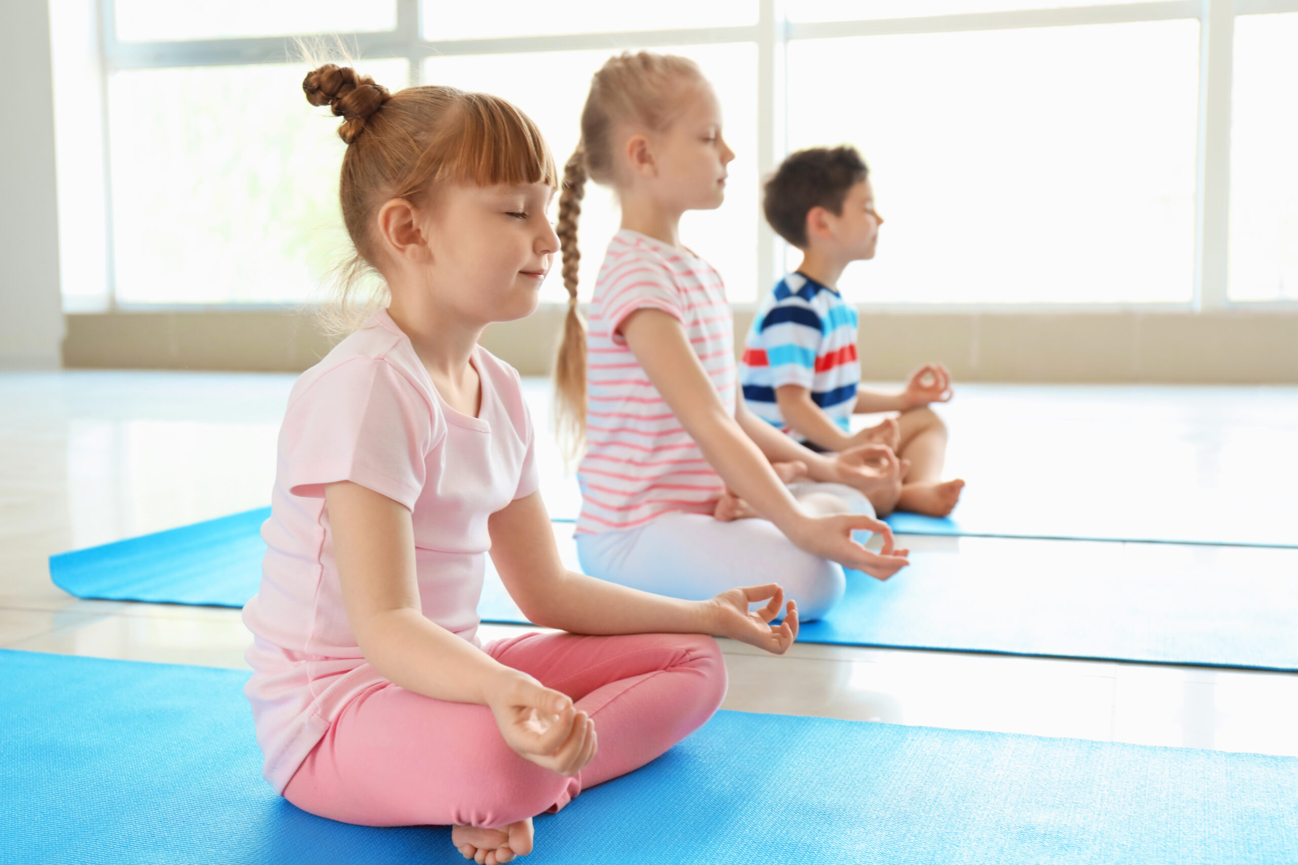Little children practicing yoga indoors